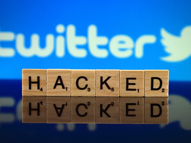 WROCLAW, POLAND - FEBRUARY 12, 2020: Word HACKED made of small wooden letters, and TWITTER logo in the background. Studio shot.